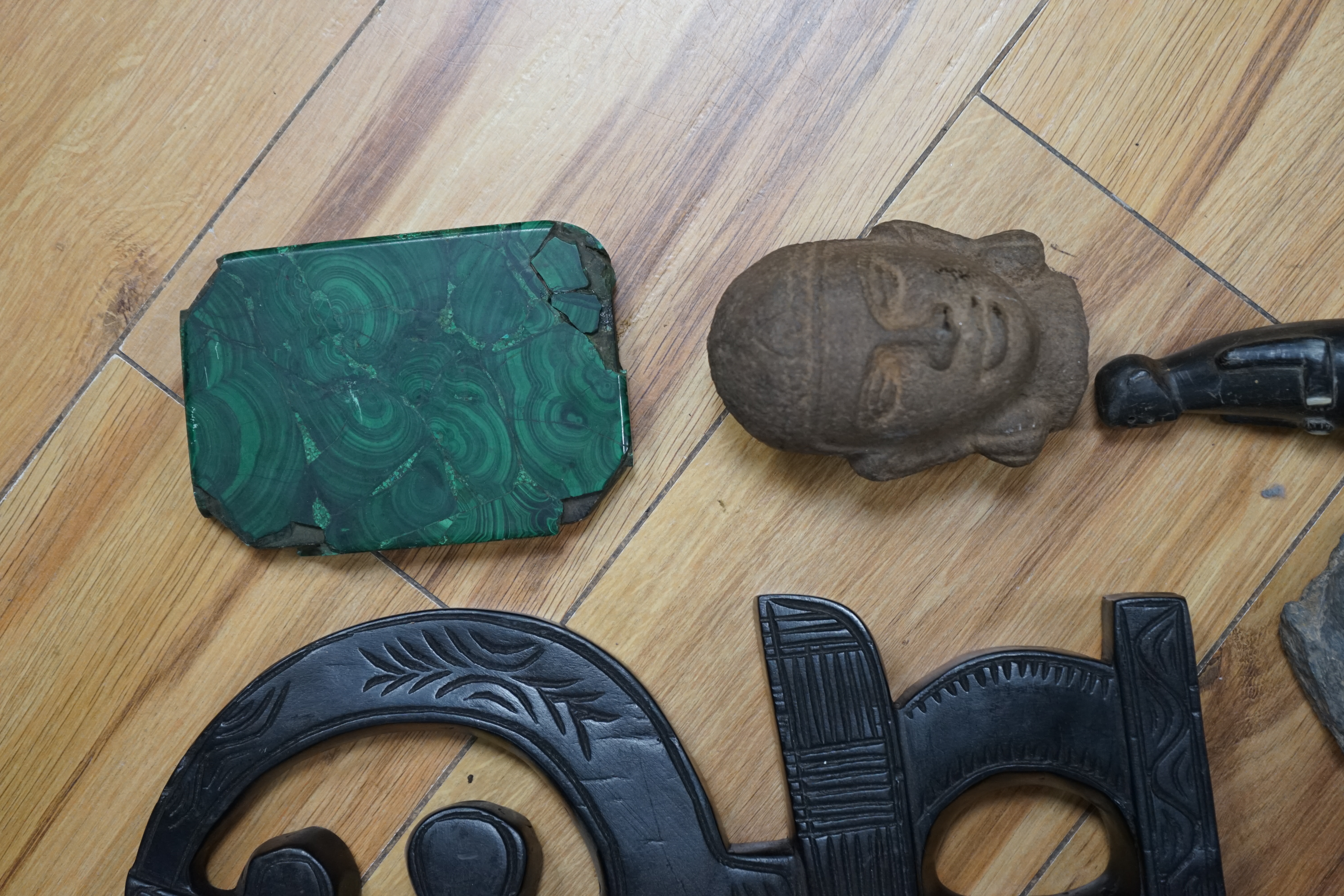 A flint axe, an inuit horn carving, a South American tribal stone head, a malachite panel, another stone carving and Chinese stand, largest 32cm. Condition - varies